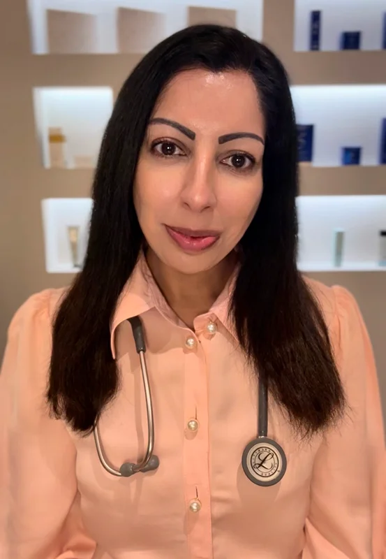 Dr Anna Puri in her clinic, wearing a stethoscope